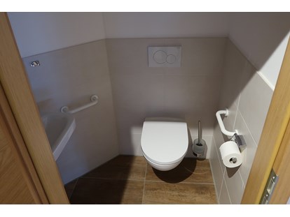 Rollstuhlgerechte Unterkunft - Unterkunftsart: Ferienwohnung - Peißenberg - WC mit Haltegriffen und Waschbecken - Barrierefreies Appartement in Pfronten
