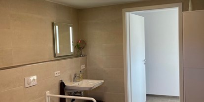 Rollstuhlgerechte Unterkunft - See - Loßburg - Die Toilette mit klappbaren Stützgriffen - Ferienwohnung Westweg