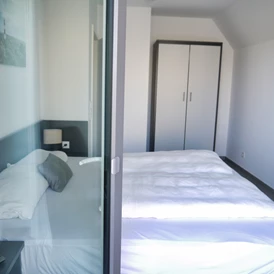 Rollstuhl-Urlaub: Schlafzimmer 3 (OG) mit Doppelbett (180x200cm), Kleiderschrank und Smart-TV - Ferienbude an den Wehlen