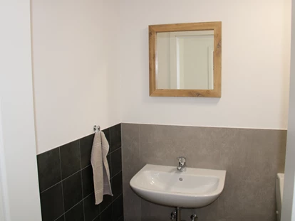 Rollstuhlgerechte Unterkunft - Pflegebett - Waschtisch und Spiegel im 2. WC - Unser Schwalbennest