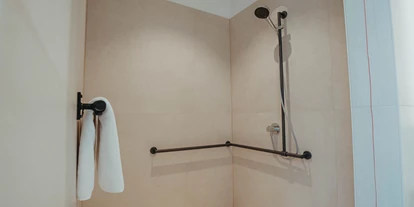 Rollstuhlgerechte Unterkunft - Pflegebett - Die Dusche ist insgesamt 150x150cm breit. Auf Wunsch stellen wir einen Stuhl - Biohotel Wildland