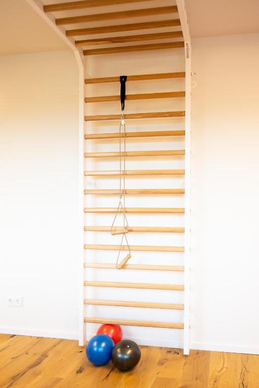 Rollstuhl-Urlaub: Aktiv bleiben – Das Fitnesscenter im Gutshof Roggow

Das hauseigene Fitnesscenter steht allen Gästen und Bewohnern kostenfrei zur Verfügung und bietet hochwertige Geräte für ein umfassendes Training: Crosstrainer, Bike und Kraftstation von Technogym, die bewährte Rudermaschine von Concept2 sowie Sprossenwand und Freihanteln. Abgerundet wird das Angebot durch einen Massagesessel – ideal zur Entspannung nach dem Training. Große Fenster sorgen für einen hellen, freundlichen Raum mit Blick ins Grüne. - Gutshof Roggow bei Güstrow