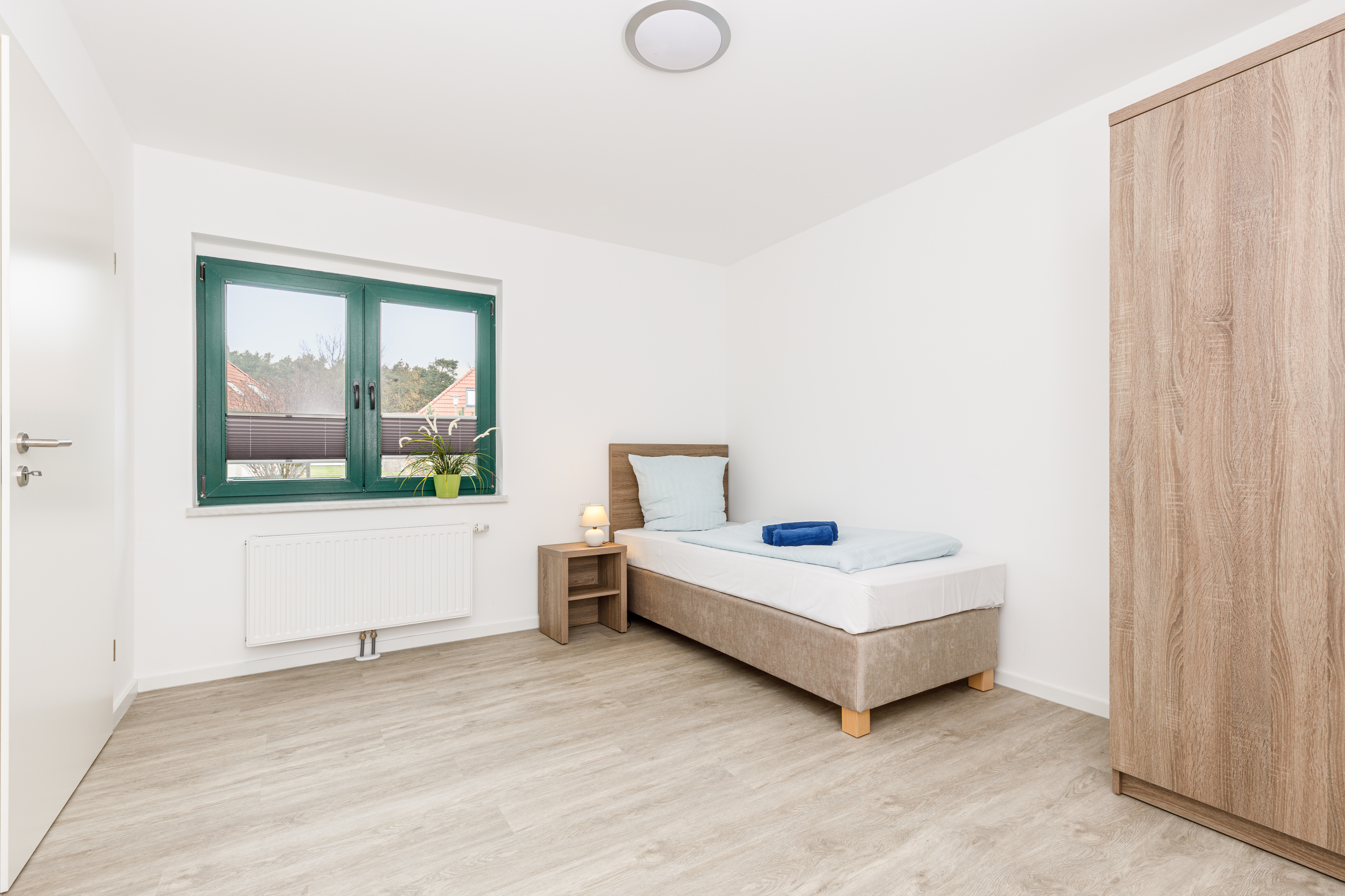 Rollstuhl-Urlaub: Schlafzimmer mit einem Bett - Feriendorf Strandgut - Appartement Dünenbude