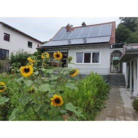 Rollstuhl-Urlaub: Haus mit   überdachter Terrasse und Blick auf den Garten - Pflegepension Weinbergweg 12