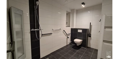 Rollstuhlgerechte Unterkunft - Unterkunftsart: Ferienhaus - Das Badezimmer verfügt über ein Waschbecken, Toilette und ebenerdige Dusche mit Sonnendusche. - IJsselmeerstraat190